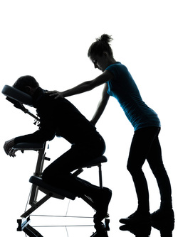 massage therapist giving chair massage